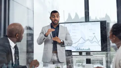 Shot of founder presenting to two investors in a meeting room