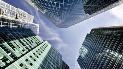 Skyscrapers and properties viewed against a backdrop of the blue sky.