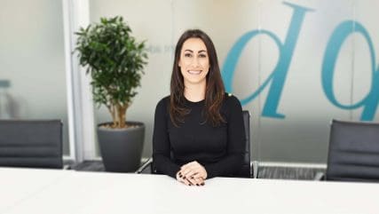 Kirsty Beck sitting at desk smiling