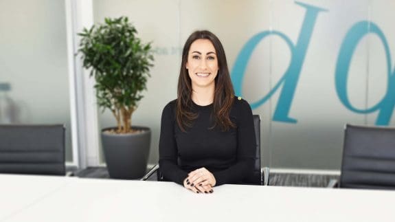Kirsty Beck sitting at desk smiling