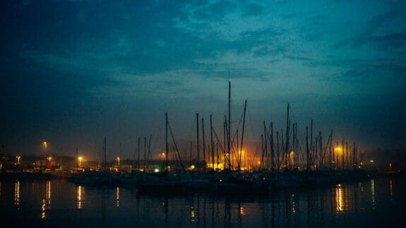 Channel Islands harbour a dusk with boats and lights in the distance