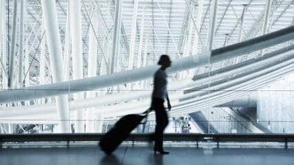 silhouette of person walking in empty building