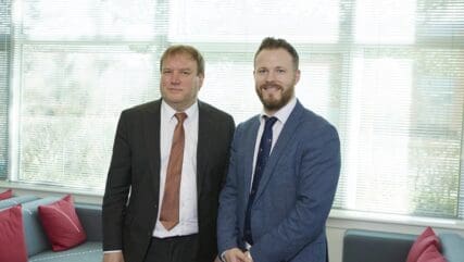 Andrew Park and Rich Grimster standing side by side in the Price Bailey office.