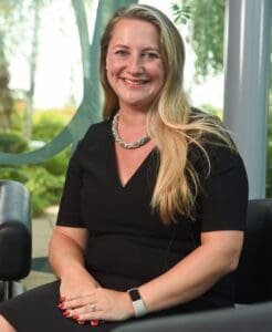 Nikita Cooper staff photo sitting in chair