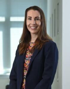 Gemma Thake staff photo standing in office smiling