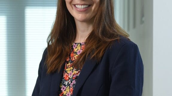 Gemma Thake staff photo standing in office smiling