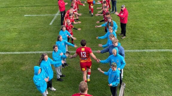 Cambridge rugby club players coming out of tunnel to pitch