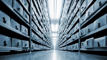 A large warehouse with rows of files in boxes