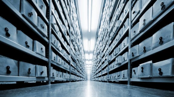 A large warehouse with rows of files in boxes