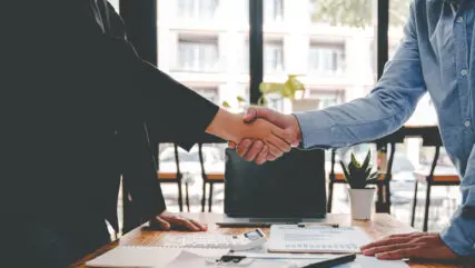 business partner handshake concept Colleagues shaking hands Successful deal after a great meeting. Blurred background.
