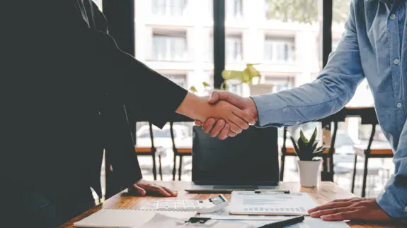 business partner handshake concept Colleagues shaking hands Successful deal after a great meeting. Blurred background.