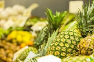 Pineapples stacked together in a market.