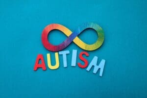 Autism rainbow infinity symbol on a blue background.