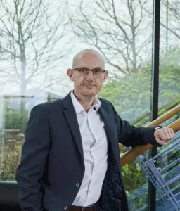 Stephen Reed standing in office smiling