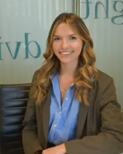 Eleanor Lodge Staff headshot sitting at desk smiling