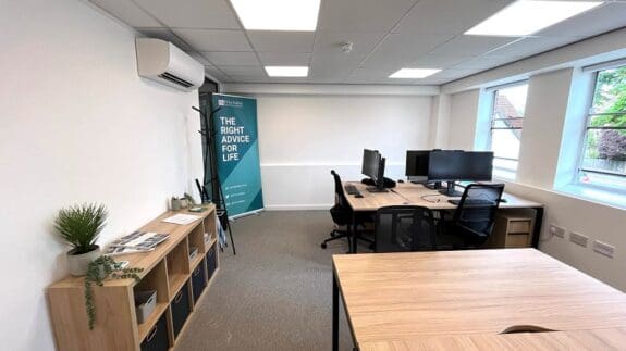 interior of empty office with desks and computer screens