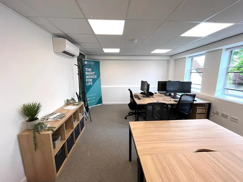 interior of empty office with desks and computer screens
