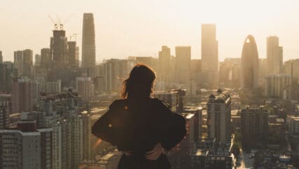 Rear view of Woman looking at London city in Sunlight