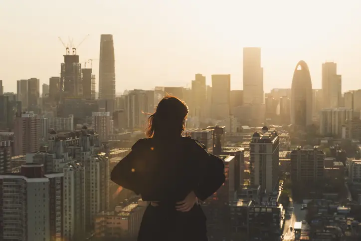 Rear view of Woman looking at London city in Sunlight