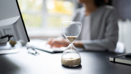 Accountant Woman Working With Invoice And Hourglass