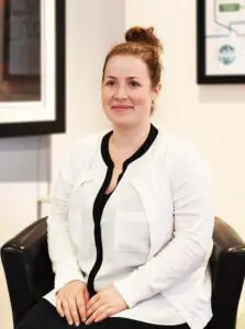 India sitting in office smiling