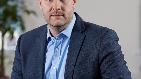 Lewis Ratcliffe sitting in office