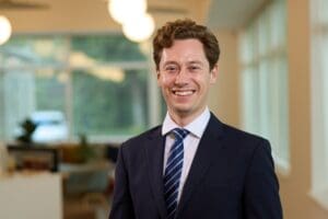 Image of James Bloxham stood in the Price Bailey Cambridge office.