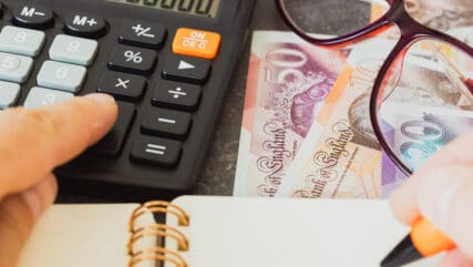 Financial settlements in Britain Pounds, Financial analysis, Tax calculation, Risk costs, business project. UK money, close up.