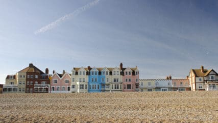 The colourful row of seafront houses in the popular coastal town of Aldeburgh, Suffolk, UK on a sunny spring day.