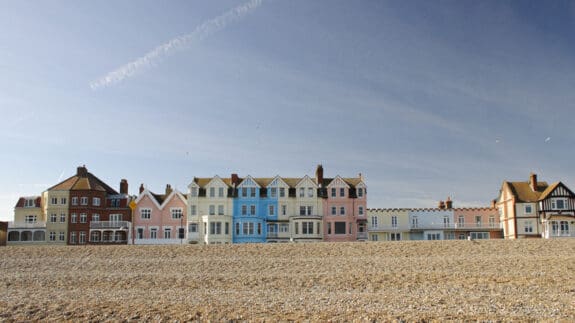 The colourful row of seafront houses in the popular coastal town of Aldeburgh, Suffolk, UK on a sunny spring day.