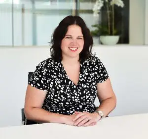 Claire Berry sitting at desk smiling