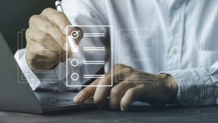 man at desk with icon overview of checkboxes