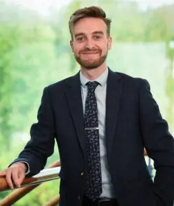 Photo of Adam Palmer stood in the Price Bailey Norwich office.