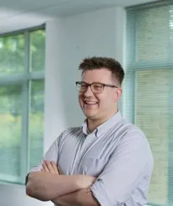 Photo of James Hart stood in the Price Bailey Cambridge office.