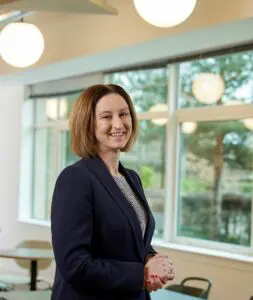 Photo of Suzanne Goldsmith stood in the Price Bailey Cambridge office. 
