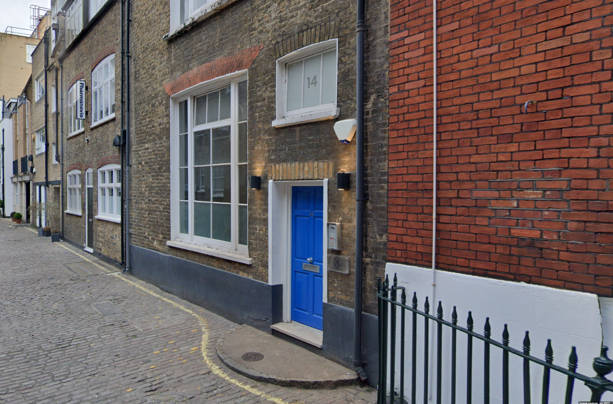 cobbled streets with buildings and blue door