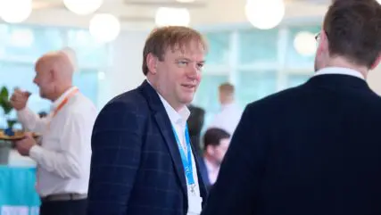 Andrew Parks standing in Cambridge office talking