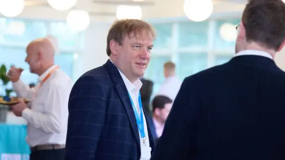 Andrew Parks standing in Cambridge office talking