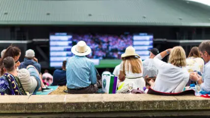 Crowd of people enjoying tennis on the hill, Wimbledon, UK