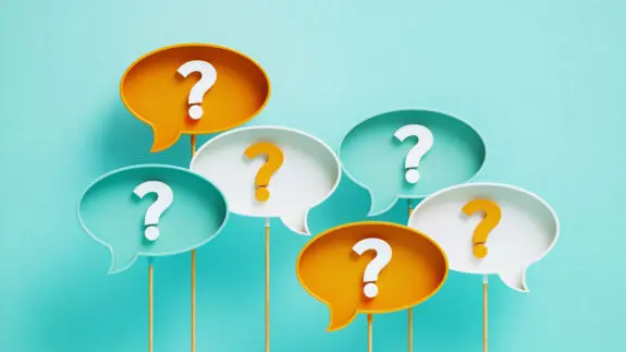 Question Marks Written Speech Bubbles On Blue Background