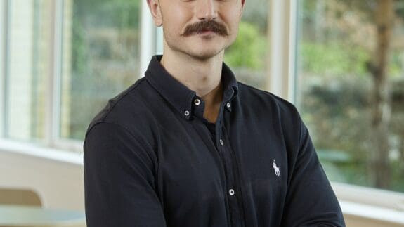 Tomas Walters standing in Cambridge office