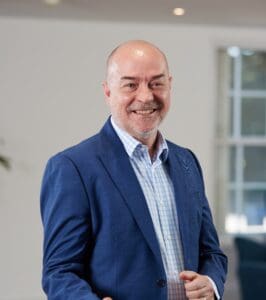 Stuart Curtis staff photo, standing in office