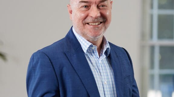 Stuart Curtis staff photo, standing in office