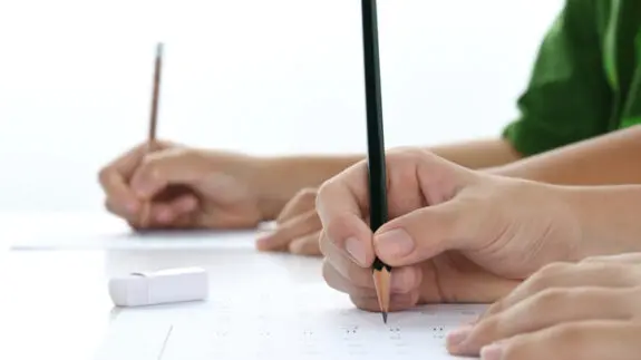 Children's hands studying in classroom