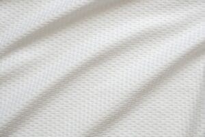 A close up image of a white textile.