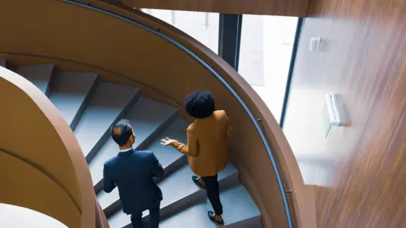 Business Colleagues Discussing on Spiral Staircase