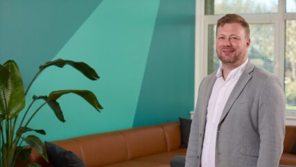 Anthony Davis partner standing in Cambridge office
